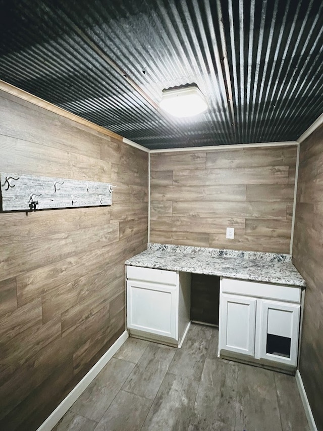 bathroom featuring wood walls