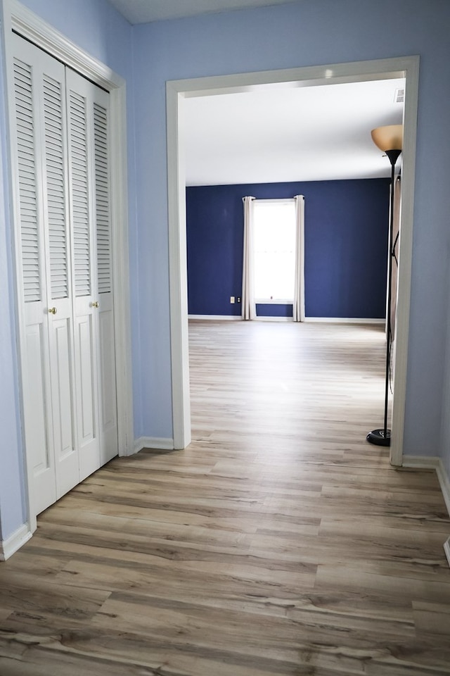 corridor with hardwood / wood-style floors