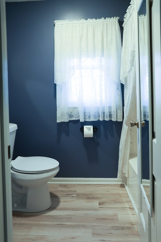 bathroom featuring hardwood / wood-style floors and toilet