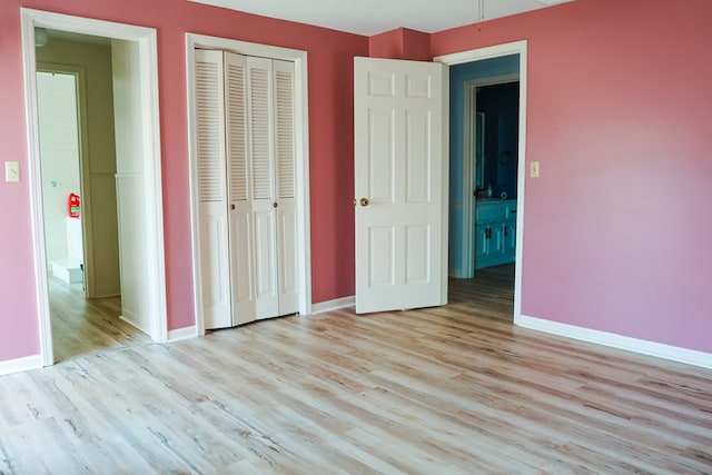 unfurnished bedroom featuring a closet and light hardwood / wood-style flooring