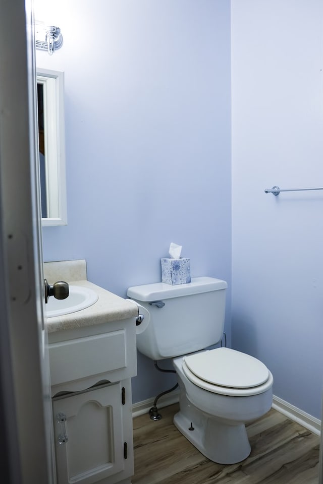 bathroom featuring vanity, toilet, and wood-type flooring