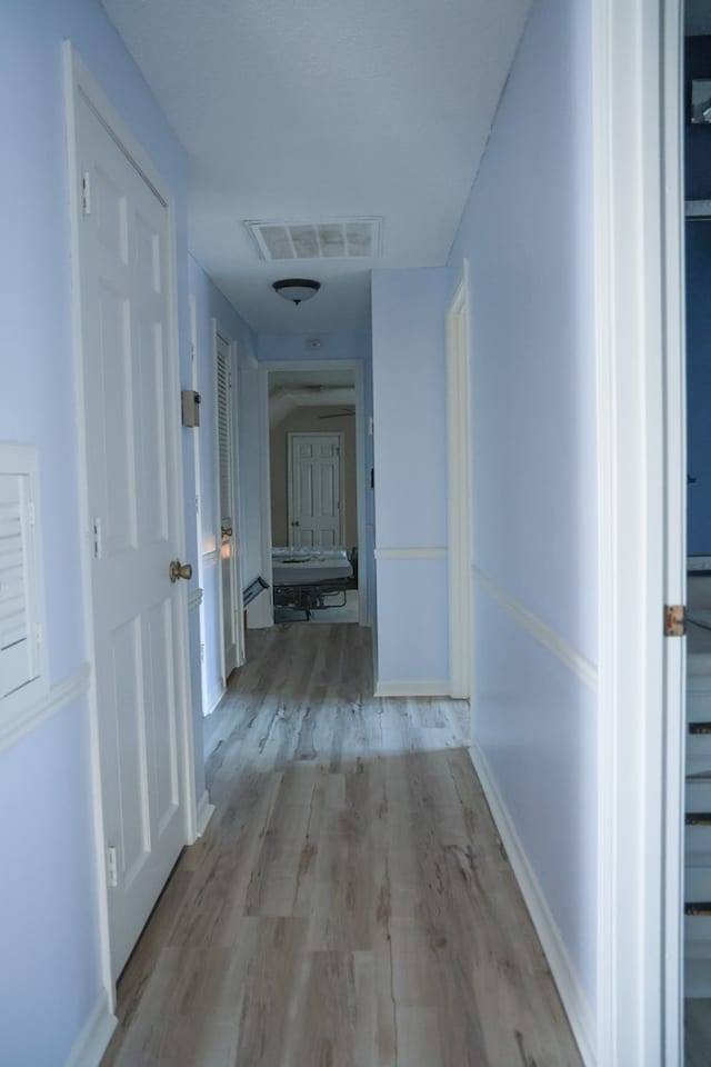 corridor featuring light hardwood / wood-style floors