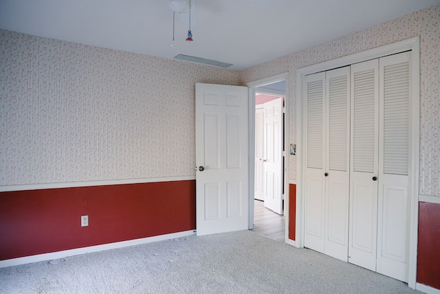 unfurnished bedroom with carpet flooring and a closet