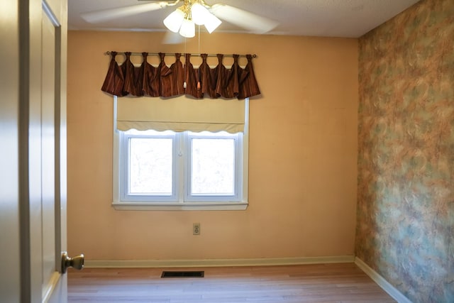 spare room with ceiling fan and light hardwood / wood-style floors