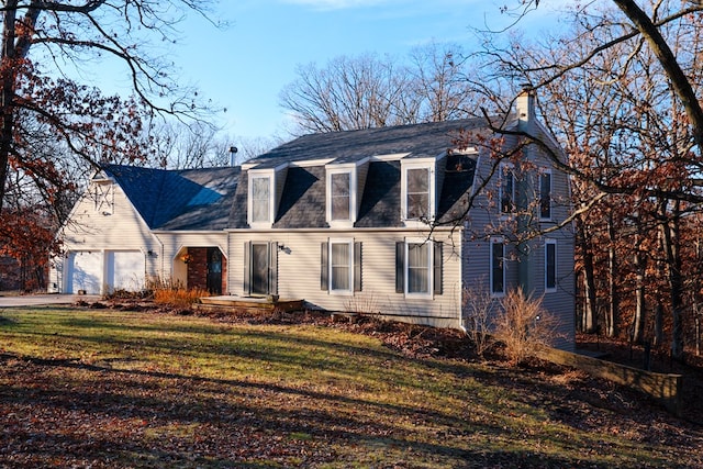 view of front facade with a front lawn and a garage