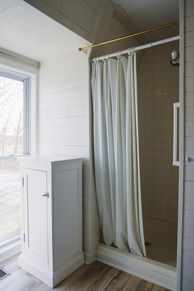 bathroom featuring hardwood / wood-style flooring and a shower with shower curtain