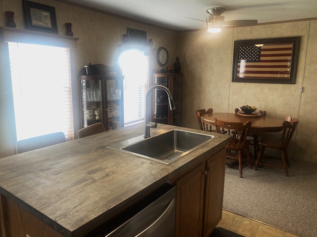 302 Mead St, Utica, MO 64686 - kitchen featuring a sink, a textured ceiling, a center island with sink, dishwasher, and a ceiling fan