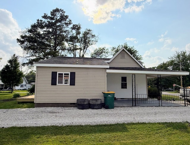 120 W Caldwell St, La Plata, MO 63549 - rear view of house with a porch, crawl space, and roof with shingles