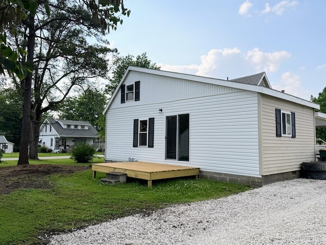 120 W Caldwell St, La Plata, MO 63549 - back of property with a deck and a lawn