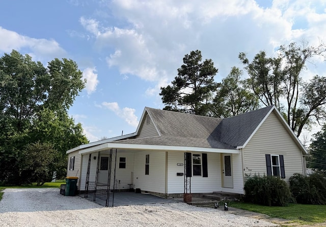 120 W Caldwell St, La Plata, MO 63549 - view of front of home featuring driveway, a carport, and a shingled roof