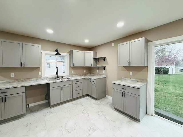120 W Caldwell St, La Plata, MO 63549 - kitchen featuring gray cabinets, open shelves, recessed lighting, light marble finish floors, and light countertops