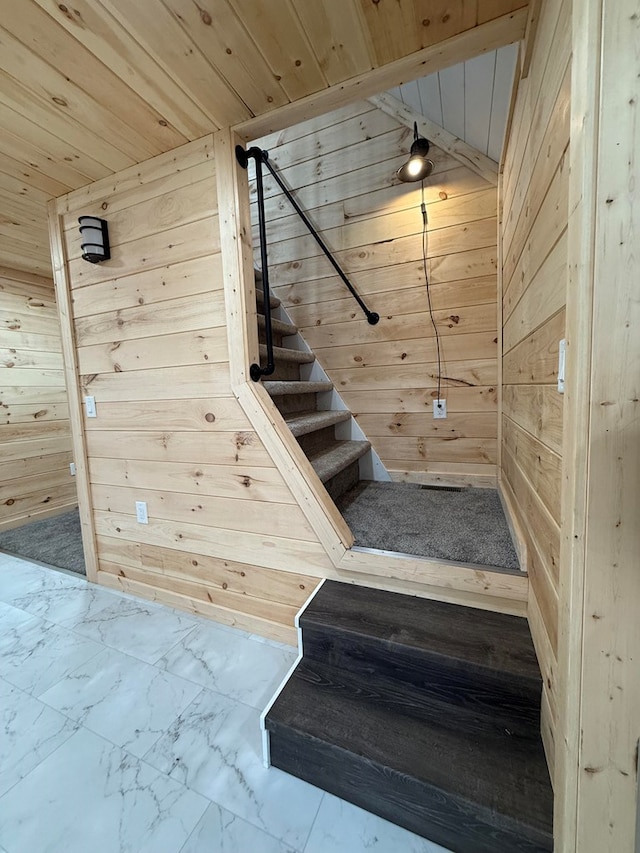 120 W Caldwell St, La Plata, MO 63549 - stairway featuring wooden walls, wooden ceiling, and marble look tile flooring