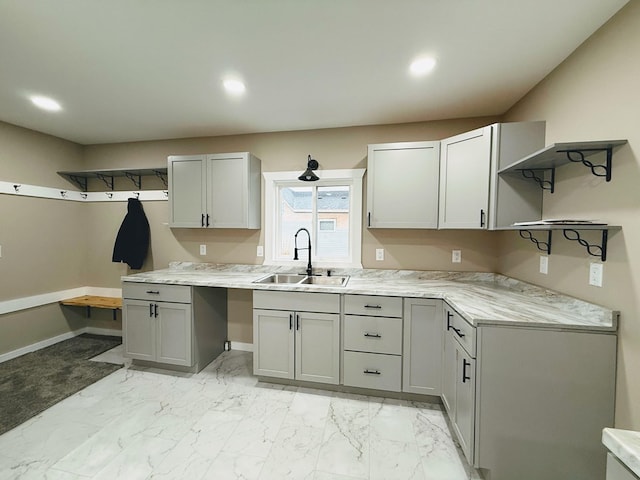 120 W Caldwell St, La Plata, MO 63549 - kitchen with open shelves, light countertops, recessed lighting, light marble finish flooring, and gray cabinetry