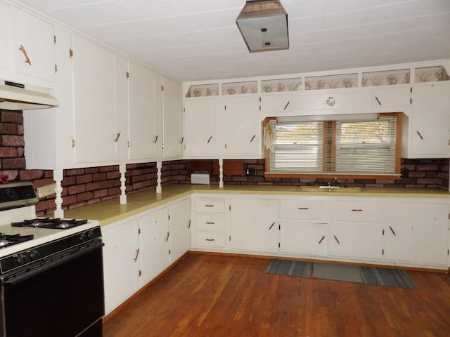 kitchen featuring sink, white cabinetry, dark wood-type flooring, and gas range gas stove