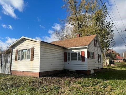 view of side of home featuring a lawn