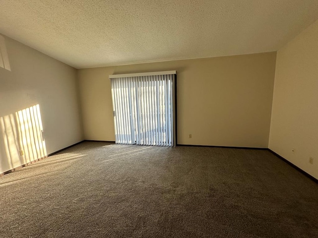 unfurnished room featuring carpet, baseboards, and a textured ceiling