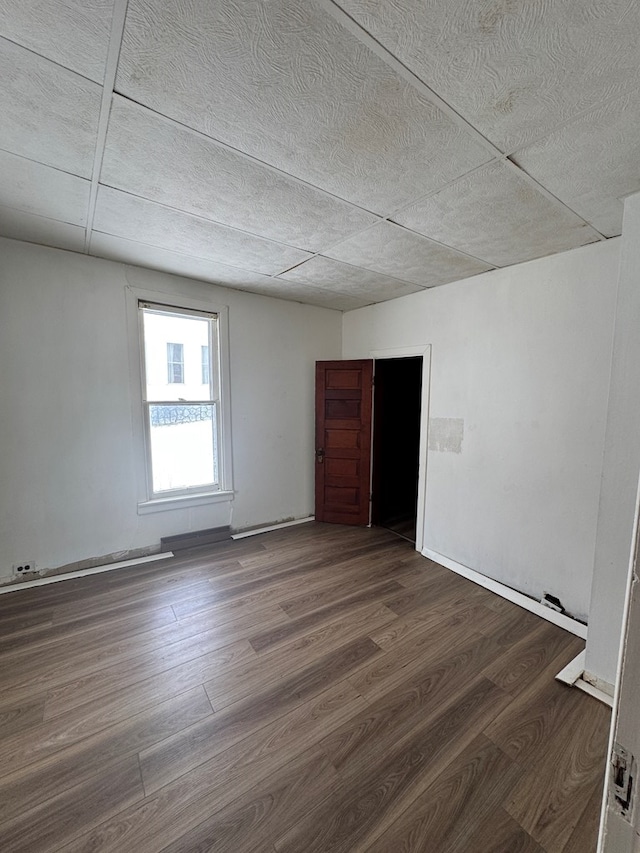 unfurnished room featuring dark wood-type flooring