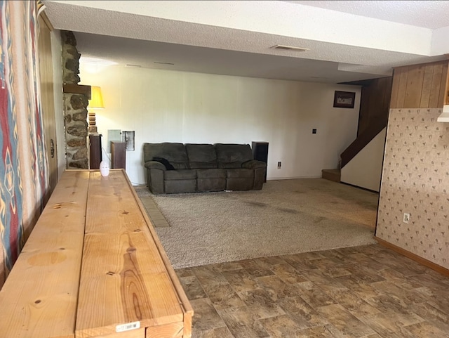 carpeted living room with a textured ceiling