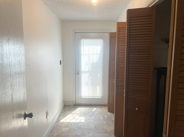 entryway featuring plenty of natural light and a textured ceiling