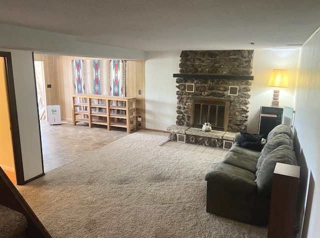 living room with carpet flooring and a stone fireplace