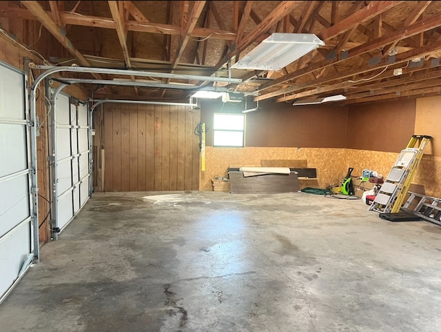 garage featuring wood walls