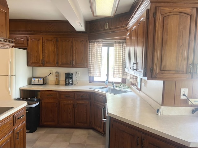 kitchen featuring white fridge, light tile patterned flooring, and sink