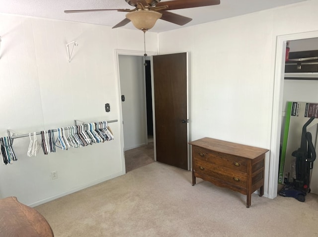 bedroom with ceiling fan and light colored carpet