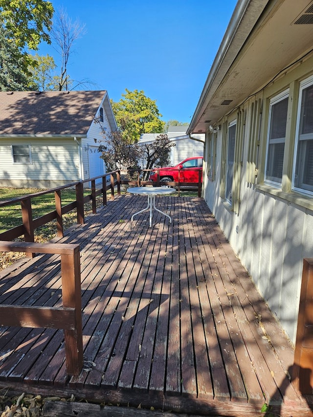 deck with an outbuilding and a garage