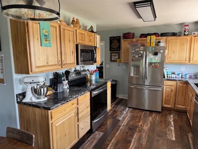 24240 State Highway T, Excello, MO 65247 - kitchen with appliances with stainless steel finishes, dark wood finished floors, dark stone counters, and light brown cabinets