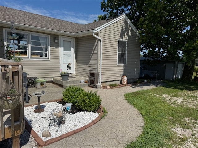 24240 State Highway T, Excello, MO 65247 - view of front of house with roof with shingles and a front lawn