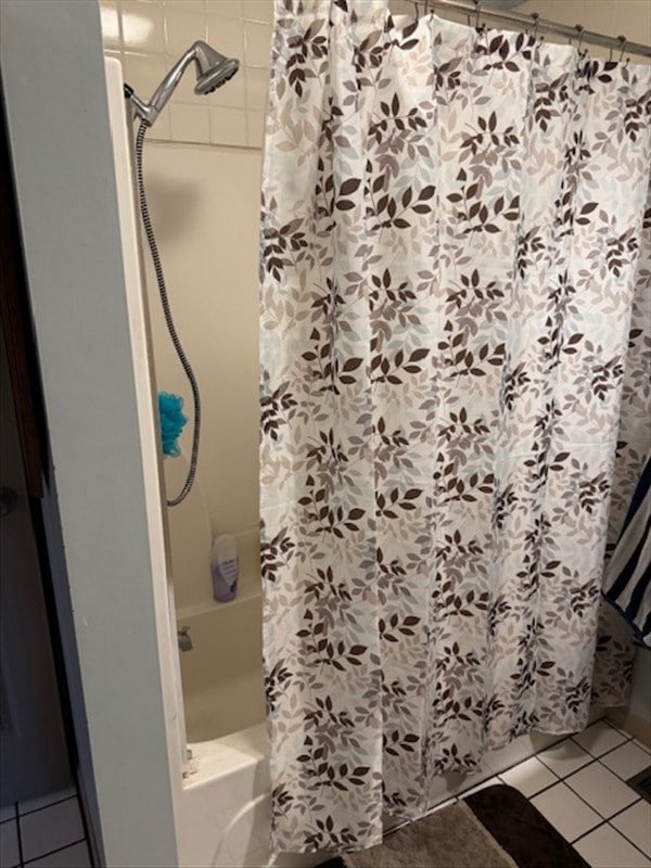 24240 State Highway T, Excello, MO 65247 - bathroom featuring shower / tub combo and tile patterned flooring