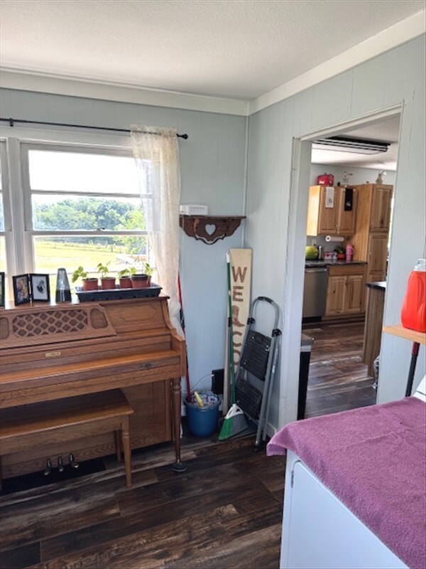 24240 State Highway T, Excello, MO 65247 - bedroom featuring dark wood-style floors, ornamental molding, and a textured ceiling