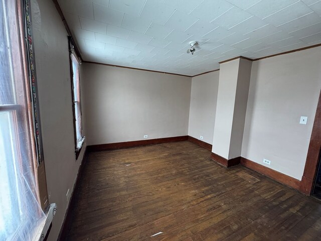 spare room featuring dark wood-type flooring