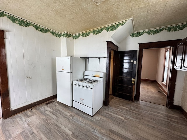 kitchen featuring dark wood-type flooring and white appliances