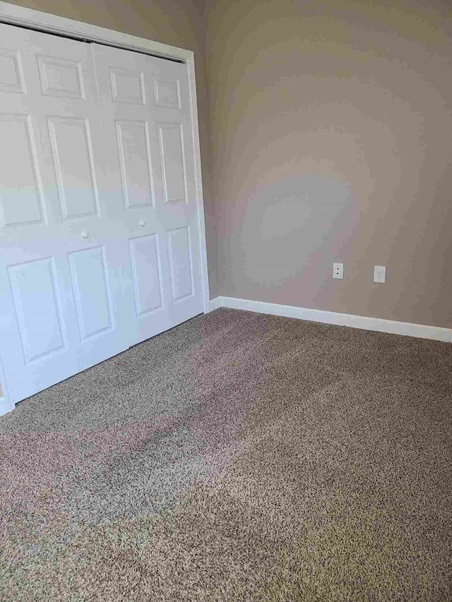 601/603 W Laharpe St, Kirksville, MO 63501 - unfurnished bedroom featuring a closet, carpet flooring, and baseboards