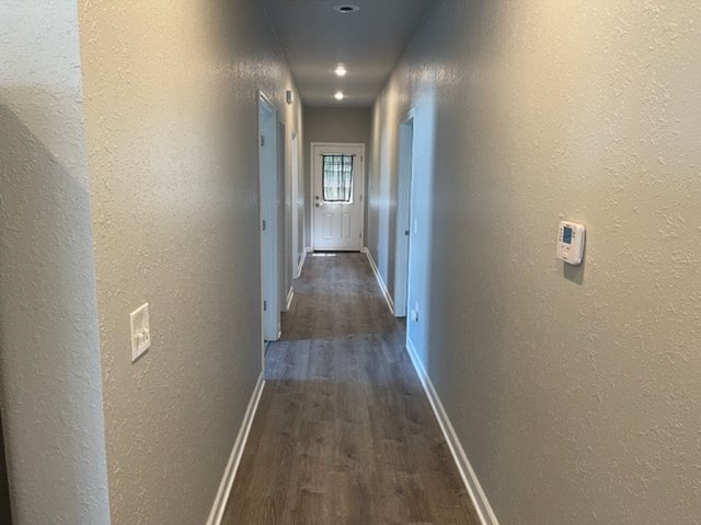 601/603 W Laharpe St, Kirksville, MO 63501 - hall featuring a textured wall, dark wood-style floors, and baseboards