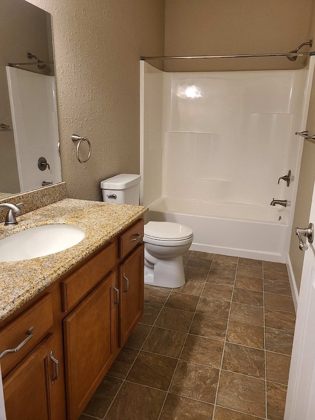 601/603 W Laharpe St, Kirksville, MO 63501 - bathroom with toilet, vanity, a textured wall, and  shower combination