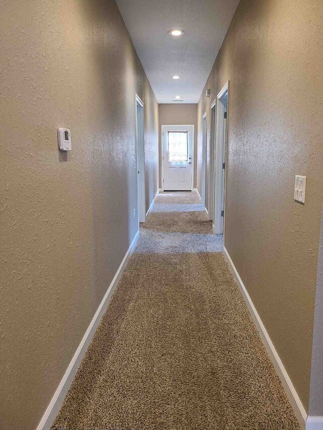 601/603 W Laharpe St, Kirksville, MO 63501 - hall featuring carpet flooring, a textured wall, and baseboards