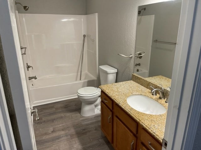 601/603 W Laharpe St, Kirksville, MO 63501 - bathroom featuring toilet, shower / tub combination, vanity, and wood finished floors