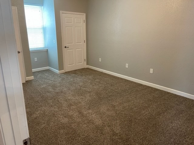 601/603 W Laharpe St, Kirksville, MO 63501 - unfurnished room with dark colored carpet and baseboards