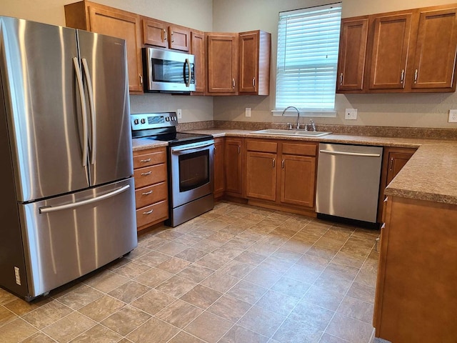 601/603 W Laharpe St, Kirksville, MO 63501 - kitchen featuring brown cabinets, appliances with stainless steel finishes, and a sink