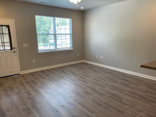601/603 W Laharpe St, Kirksville, MO 63501 - interior space featuring dark wood-type flooring, visible vents, baseboards, and ceiling fan