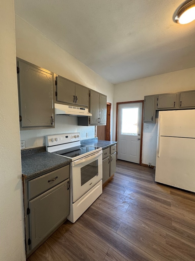 kitchen featuring white appliances, dark hardwood / wood-style floors, and gray cabinets