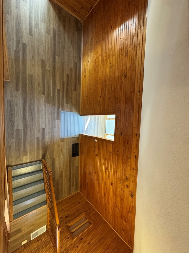 clothes washing area featuring wooden walls and wooden ceiling