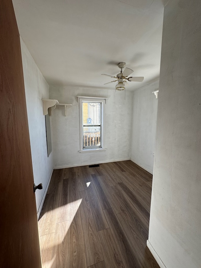 spare room with ceiling fan and dark hardwood / wood-style flooring