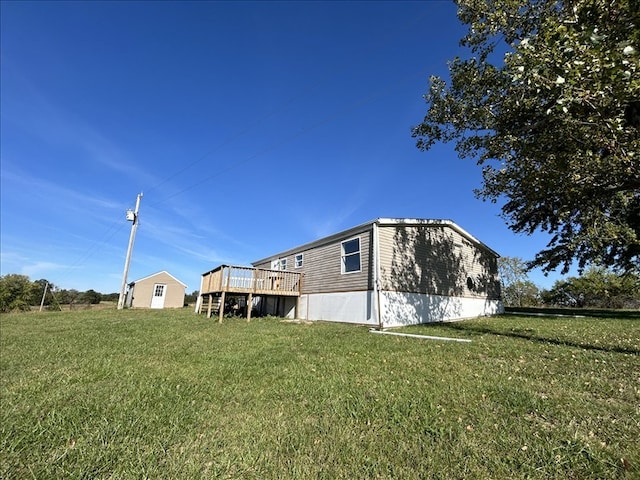 back of house featuring a deck and a yard