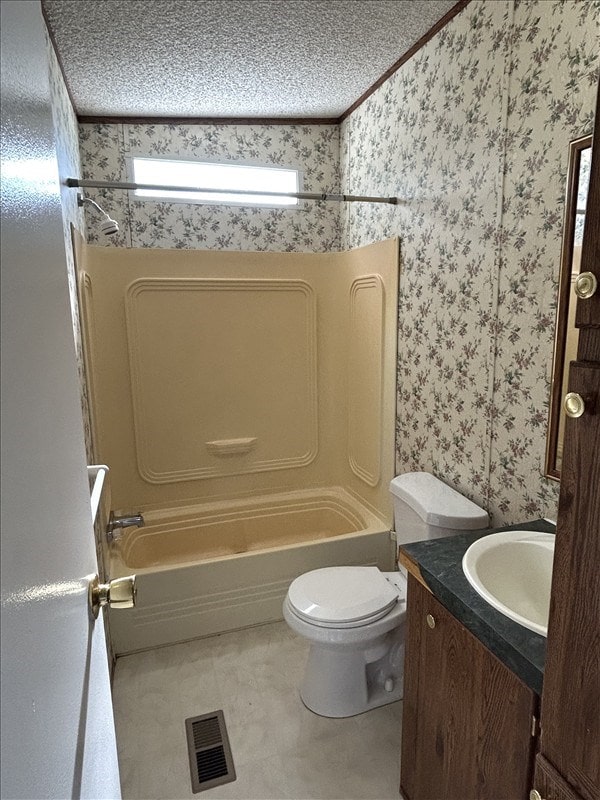 full bathroom with shower / washtub combination, vanity, a textured ceiling, and toilet