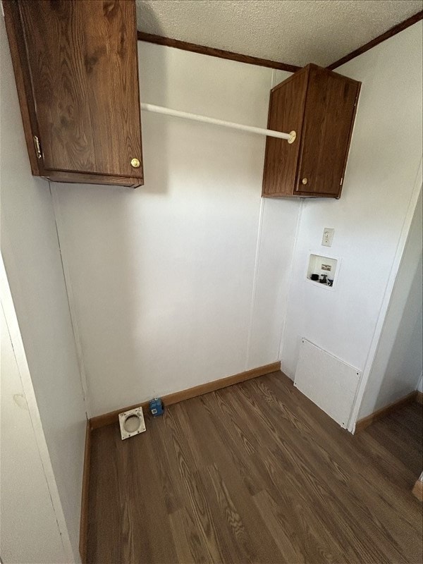 laundry room featuring cabinets, hookup for a washing machine, a textured ceiling, and dark hardwood / wood-style floors