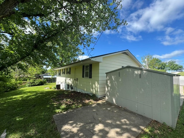 236 N Maple St, Milan, MO 63556 - back of house with a yard, a patio, a garage, and central air condition unit