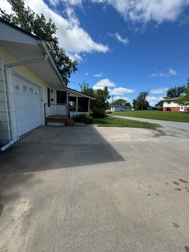 236 N Maple St, Milan, MO 63556 - view of front facade featuring concrete driveway and a garage